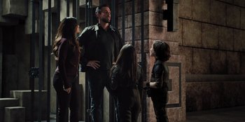 Movie still from “Spy Kids: Armageddon” (2023), directed by Robert Rodriguez – A group of people standing next to each other in a room; Medium shot, Low angle