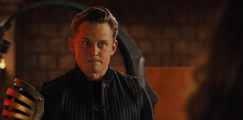 Movie still from “Spy Kids: Armageddon” (2023), directed by Robert Rodriguez – A person wearing a black shirt; Close Up shot, Over the shoulder angle