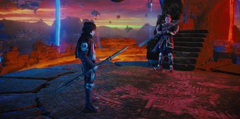 Movie still from “Spy Kids: Armageddon” (2023), directed by Robert Rodriguez – A man and a woman standing next to each other holding weapons; Wide shot, Over the shoulder angle