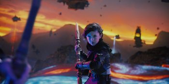 Movie still from “Spy Kids: Armageddon” (2023), directed by Robert Rodriguez – A young boy is holding a sword in front of an alien landscape; Medium shot, Low angle