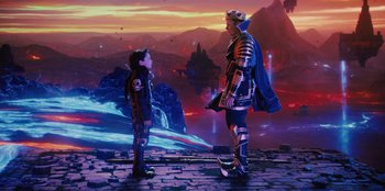 Movie still from “Spy Kids: Armageddon” (2023), directed by Robert Rodriguez – A man and a boy standing next to each other; Wide shot, High angle