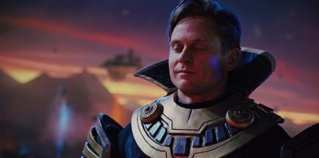 Movie still from “Spy Kids: Armageddon” (2023), directed by Robert Rodriguez – A man in a costume is looking up at the sky; Close Up shot, Over the shoulder angle