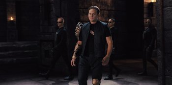 Movie still from “Spy Kids: Armageddon” (2023), directed by Robert Rodriguez – A group of men walking down a street; Medium shot, Low angle