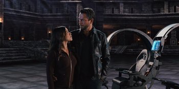 Movie still from “Spy Kids: Armageddon” (2023), directed by Robert Rodriguez – A man and a woman standing next to each other; Medium shot, Over the shoulder angle