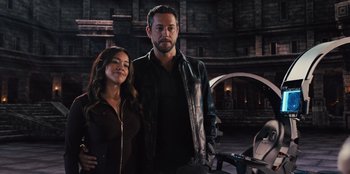 Movie still from “Spy Kids: Armageddon” (2023), directed by Robert Rodriguez – A man and a woman standing next to each other; Medium shot, Low angle