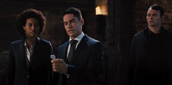 Movie still from “Spy Kids: Armageddon” (2023), directed by Robert Rodriguez – A man in a suit and tie looking at a cell phone; Close Up shot, Over the shoulder angle