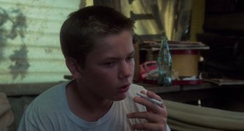 Movie still from “Stand by Me” (1986), directed by Rob Reiner – A young man holding a cigarette in his mouth; Close Up shot, Low angle