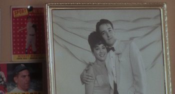 Movie still from “Stand by Me” (1986), directed by Rob Reiner – An old photo of a man and a woman in formal wear; Extreme Close Up shot, Low angle
