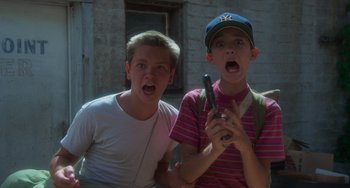Movie still from “Stand by Me” (1986), directed by Rob Reiner – Two young men are standing next to each other; Close Up shot, Low angle