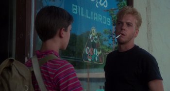 Movie still from “Stand by Me” (1986), directed by Rob Reiner – A man smoking a cigarette while talking to a young boy; Close Up shot, Over the shoulder angle