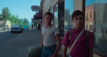 Movie still from “Stand by Me” (1986), directed by Rob Reiner – Two young men standing on the side of the street; Medium shot, Low angle