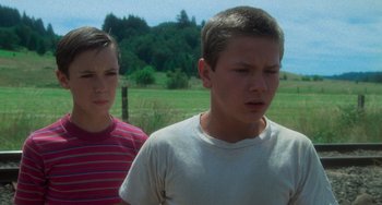 Movie still from “Stand by Me” (1986), directed by Rob Reiner – Two young people standing in a field looking at something; Close Up shot, Low angle