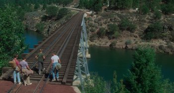 Movie still from “Stand by Me” (1986), directed by Rob Reiner – Two people walking across a bridge over a river; Extreme Wide shot, High angle
