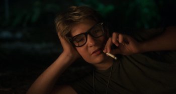 Movie still from “Stand by Me” (1986), directed by Rob Reiner – A man with glasses is talking on a cell phone; Close Up shot, Over the shoulder angle