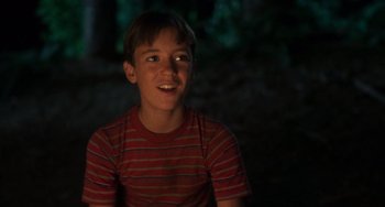 Movie still from “Stand by Me” (1986), directed by Rob Reiner – A young boy in a red striped shirt is smiling; Close Up shot, Low angle