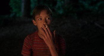 Movie still from “Stand by Me” (1986), directed by Rob Reiner – A young boy is smoking a cigarette in the dark; Close Up shot, Low angle