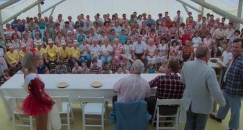 Movie still from “Stand by Me” (1986), directed by Rob Reiner – A large group of people sitting around a table; Wide shot, High angle