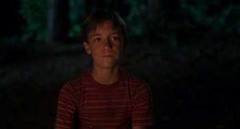 Movie still from “Stand by Me” (1986), directed by Rob Reiner – A young boy in a red striped t - shirt; Close Up shot, Low angle