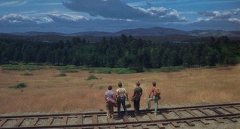 Movie still from “Stand by Me” (1986), directed by Rob Reiner – A group of people standing on top of a train track; Wide shot, High angle