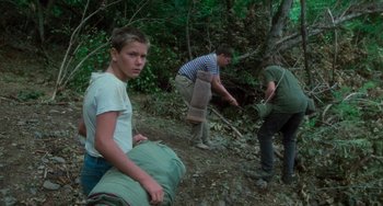Movie still from “Stand by Me” (1986), directed by Rob Reiner – A group of people working in the woods; Medium shot, High angle