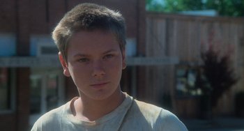 Movie still from “Stand by Me” (1986), directed by Rob Reiner – A young man is looking into the camera; Close Up shot, Low angle