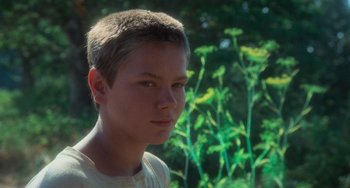 Movie still from “Stand by Me” (1986), directed by Rob Reiner – A young man with a short haircut looks into the camera; Close Up shot, Low angle