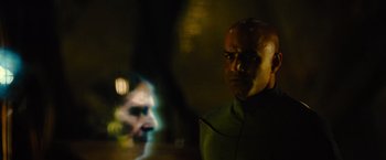 Movie still from “Star Trek” (2009), directed by J.J. Abrams – A man with a bald head is looking into the camera; Close Up shot, Over the shoulder angle