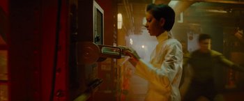 Movie still from “Star Trek” (2009), directed by J.J. Abrams – A woman in a white lab coat is holding a machine; Medium shot, Low angle