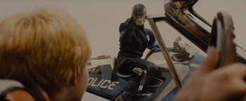 Movie still from “Star Trek” (2009), directed by J.J. Abrams – A person on a police motorcycle with a helmet on; Medium shot, Over the shoulder angle