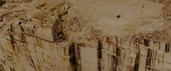 Movie still from “Star Trek” (2009), directed by J.J. Abrams – An aerial view of a car driving on a road next to a wall; Extreme Wide shot, Overhead angle