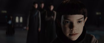 Movie still from “Star Trek” (2009), directed by J.J. Abrams – A boy is standing in front of a group of people; Close Up shot, Over the shoulder angle