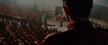 Movie still from “Star Trek” (2009), directed by J.J. Abrams – A man standing in front of an audience at a podium; Wide shot, Over the shoulder angle