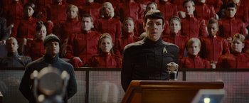 Movie still from “Star Trek” (2009), directed by J.J. Abrams – A man standing in front of a group of people; Medium shot, Over the shoulder angle