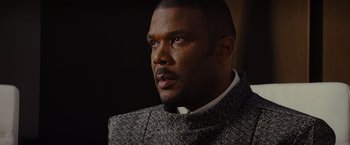 Movie still from “Star Trek” (2009), directed by J.J. Abrams – A person wearing a suit and tie; Close Up shot, Over the shoulder angle