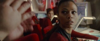 Movie still from “Star Trek” (2009), directed by J.J. Abrams – A woman sitting on a red seat on a bus; Close Up shot, Over the shoulder angle