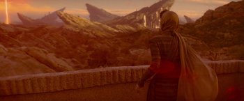 Movie still from “Star Trek” (2009), directed by J.J. Abrams – A woman standing on a ledge looking out at a mountain range; Extreme Wide shot, Over the shoulder angle