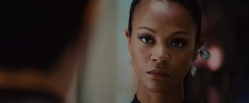 Movie still from “Star Trek” (2009), directed by J.J. Abrams – A woman's face in a black shirt; Close Up shot, Over the shoulder angle