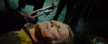 Movie still from “Star Trek” (2009), directed by J.J. Abrams – A man getting his hair cut with a pair of shears; Close Up shot, Low angle