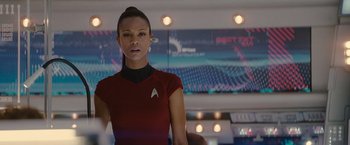 Movie still from “Star Trek” (2009), directed by J.J. Abrams – A woman in red shirt standing in a room; Close Up shot, Over the shoulder angle