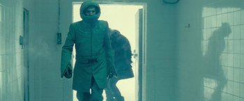 Movie still from “Star Trek” (2009), directed by J.J. Abrams – A man dressed in green is standing in front of a door; Medium shot, Low angle