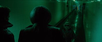 Movie still from “Star Trek” (2009), directed by J.J. Abrams – A person in a dark room next to a green wall; Medium shot, Over the shoulder angle
