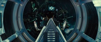 Movie still from “Star Trek” (2009), directed by J.J. Abrams – A man is sitting inside of an airplane looking down; Wide shot, Overhead angle