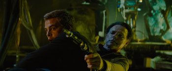 Movie still from “Star Trek” (2009), directed by J.J. Abrams – A man holding a gun in front of another man; Close Up shot, Over the shoulder angle