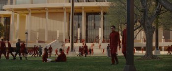 Movie still from “Star Trek” (2009), directed by J.J. Abrams – A group of people in red suits in front of a building; Extreme Wide shot, High angle