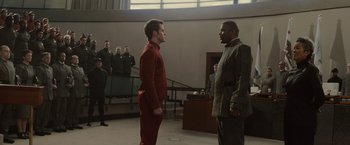 Movie still from “Star Trek” (2009), directed by J.J. Abrams – Two men are standing side by side in front of a group of people; Wide shot, Over the shoulder angle