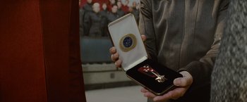Movie still from “Star Trek” (2009), directed by J.J. Abrams – A person holding a medal in a box; Extreme Close Up shot, High angle