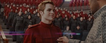 Movie still from “Star Trek” (2009), directed by J.J. Abrams – A man in a red suit standing in front of a crowd; Close Up shot, Over the shoulder angle