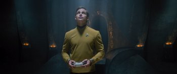 Movie still from “Star Trek Beyond” (2016), directed by Justin Lin – A man in a star trek uniform holding a game controller; Medium shot, Low angle