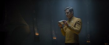 Movie still from “Star Trek Beyond” (2016), directed by Justin Lin – A man holding a nintendo wii game controller in his hands; Medium shot, Over the shoulder angle