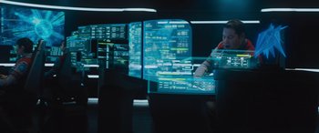 Movie still from “Star Trek Beyond” (2016), directed by Justin Lin – A man sitting in front of computer screens; Wide shot, Low angle